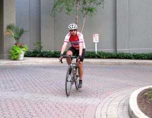 Eric Londin Riding His Bike on Campus