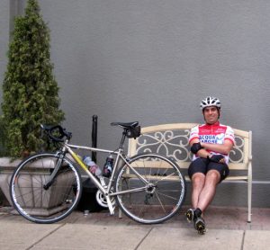 Cyclist and Professor, Eric Londin, Sitting on Bench Next to Bike