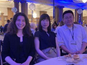 Venetia, Megumi, and Yohei Smiling from Table at 5 Year Celebration